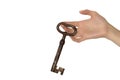 Woman hand with old key on white background Royalty Free Stock Photo