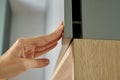 Woman hand open kitchen cabinet, Cupboard door Royalty Free Stock Photo