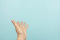 Woman hand open palm up gesture. Female hand taking, giving, showing something on light blue background. First person Royalty Free Stock Photo