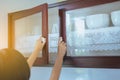 Woman with hand opening Built-in cabinet interior decoration in kitchen Royalty Free Stock Photo