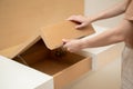 Woman hand opening cupboard of brown wooden table built in Royalty Free Stock Photo