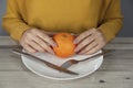 Woman hand orange on plate