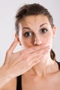 Woman with hand over mouth Royalty Free Stock Photo
