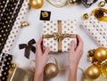 Woman hand packaging christmas gift box. Royalty Free Stock Photo