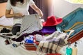 Woman hand packing a luggage for a new journey and travel for a long weekend Royalty Free Stock Photo