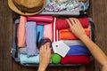 Woman hand packing a luggage for a new journey and travel Royalty Free Stock Photo