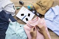 Woman hand packing a luggage for a new journey and travel for a long weekend on wooden table background Royalty Free Stock Photo