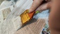 Woman hand painting on wooden boards with Brush full of white paint. Painting of new wood board or furniture and old Royalty Free Stock Photo