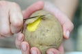 A woman hand peels potato with a knife close-up. Cooking fries. Royalty Free Stock Photo