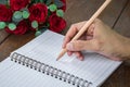 Woman hand with pencil writing on notebook Royalty Free Stock Photo