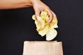 Woman hand picking potato chips stock photo Royalty Free Stock Photo