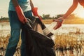 woman hand picking up garbage plastic for cleaning at river Royalty Free Stock Photo