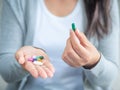 Woman hand with pills medicine tablets and capsule in her hands.