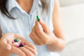 Woman hand with pills medicine tablets and capsule in her hands. Royalty Free Stock Photo