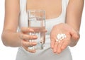 Woman hand with pills medicine tablets and glass of water Royalty Free Stock Photo