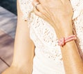 Woman hand with pink bracelet. Women& x27;s jewelry. Beautiful rose tones bracelet.