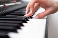 Woman hand playing a MIDI controller keyboard synthesizer close up Royalty Free Stock Photo