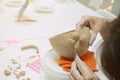 Woman hand potter making clay cup in pottery workshop studio. Process of creating ceramic mug. Handmade, hobby art and Royalty Free Stock Photo