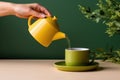 Woman hand pour tea from yellow jug, minimalist on a green table. AI Generated