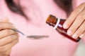 Woman hand pouring medication or antipyretic syrup from bottle to spoon. Royalty Free Stock Photo