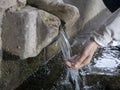 Woman hand pouring Water on nature spring