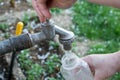 Woman hand pouring water in a plastic bottle Royalty Free Stock Photo