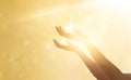 Woman hand praying for blessing from god on sunset