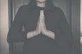 Woman with hand in praying position,Female pay respect or put your hands together position,Black and white toned