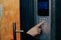 Woman hand press buttons on video intercom at entrance of apartment building in the night Royalty Free Stock Photo