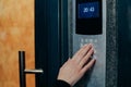 Woman hand press buttons on video intercom at entrance of apartment building in the night Royalty Free Stock Photo