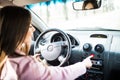 Woman with hand pressing emergency light button on car dashboard. Royalty Free Stock Photo