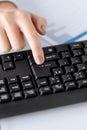 Woman hand pressing enter button on keyboard