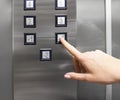 Woman hand pressing push button for elevator. Hand finger press the Elevator button. Woman using Elevator in office or apartment Royalty Free Stock Photo