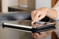 Woman hand pressing a tablet touch screen