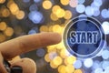 Woman hand push start button on touch screen over blue and golden bokeh background Royalty Free Stock Photo