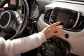 Woman hand pushing monitor screen in car Royalty Free Stock Photo