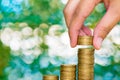 Woman hand put coin on step of coins stacks and gold coin money Royalty Free Stock Photo