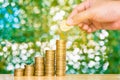 Woman hand put coin on step of coins stacks and gold coin money Royalty Free Stock Photo