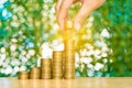 Woman hand put coin on step of coins stacks and gold coin money Royalty Free Stock Photo