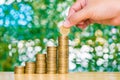 Woman hand put coin on step of coins stacks and gold coin money Royalty Free Stock Photo