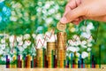 Woman hand put coin on step of coins stacks and gold coin money Royalty Free Stock Photo