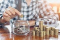 Woman hand put coins to stack of coins, a saving money for fut Royalty Free Stock Photo