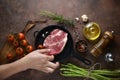 Woman hand put meat on to iron pan for preparation to marinate on ingredients background. top view, horizontal image