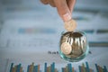 Woman hand putting coinIn the glass jar. Saving money wealth and financial concept, Personal finance, finance management, savings Royalty Free Stock Photo