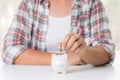 Woman hand putting money coin into piggy bank. Saving money weal Royalty Free Stock Photo