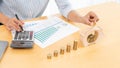 Woman hand putting money coin into piggy bank with step of growing stack coins for saving money for future investment concept Royalty Free Stock Photo