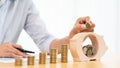 Woman hand putting money coin into piggy bank with step of growing stack coins for saving money for future investment concept Royalty Free Stock Photo