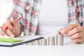 Woman hand putting money coin on stack of coins Royalty Free Stock Photo