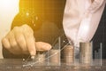 Woman hand putting money coin stack growing. Royalty Free Stock Photo