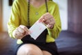 Woman hand putting sanitary napkin in handbag,White menstrual pad,Menses Royalty Free Stock Photo